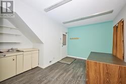 The kitchen and door leading to the back entrance. - 