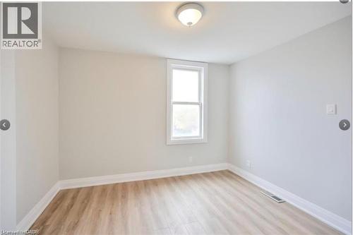 Spare room featuring baseboards and light wood-style floors - 1024 Cannon Street E, Hamilton, ON - Indoor Photo Showing Other Room