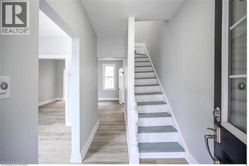 Stairway with wood finished floors and baseboards - 1024 Cannon Street E, Hamilton, ON - Indoor Photo Showing Other Room