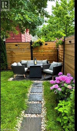 Fenced backyard with outdoor lounge area and a patio area - 1024 Cannon Street E, Hamilton, ON - Outdoor