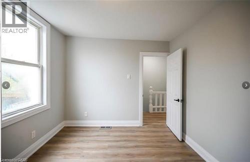 Unfurnished room with light wood-type flooring and baseboards - 1024 Cannon Street E, Hamilton, ON - Indoor Photo Showing Other Room