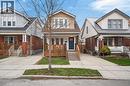 View of front of house with covered porch, brick siding, and driveway - 248 London Street S, Hamilton, ON  - Outdoor With Deck Patio Veranda With Facade 