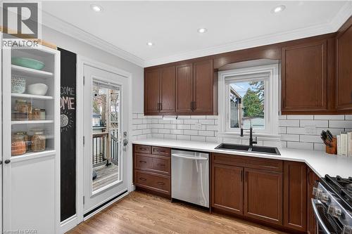 Kitchen with crown molding, stainless steel appliances, light wood-type flooring, recessed lighting, and tasteful backsplash - 248 London Street S, Hamilton, ON - Indoor Photo Showing Kitchen With Double Sink