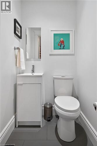 Half bath with vanity and tile patterned floors - 248 London Street S, Hamilton, ON - Indoor Photo Showing Bathroom