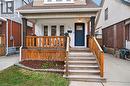Entrance to property featuring a shingled roof, a porch, and brick siding - 248 London Street S, Hamilton, ON  - Outdoor With Exterior 