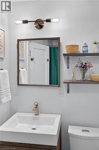 Full bath featuring vanity and a shower with shower curtain - 248 London Street S, Hamilton, ON - Indoor Photo Showing Bathroom