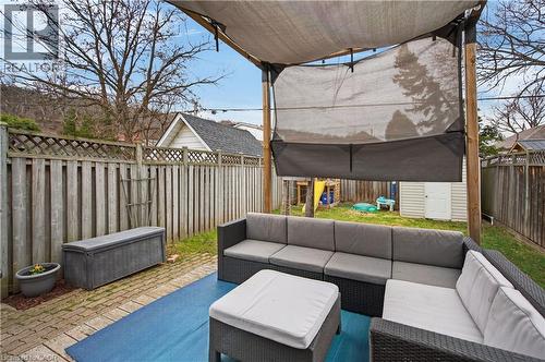 Fenced backyard with a storage shed, a patio area, and outdoor lounge area - 248 London Street S, Hamilton, ON - Outdoor With Deck Patio Veranda With Exterior