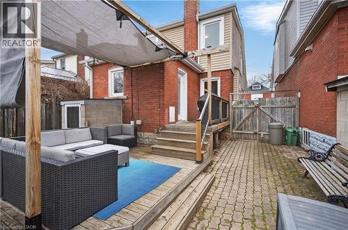 Rear view of property with a gate, a patio area, outdoor seating, brick siding, and a deck - 248 London Street S, Hamilton, ON - Outdoor With Deck Patio Veranda With Exterior