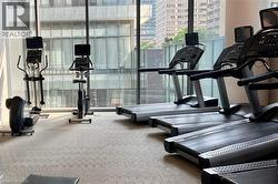Gym area with expansive windows and a view of the city - 