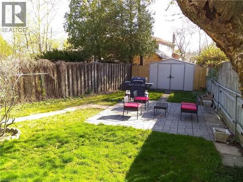 Fenced backyard with a patio and a storage unit - 1492 Sandgate Crescent Unit# Upper, Mississauga, ON - Outdoor With Backyard