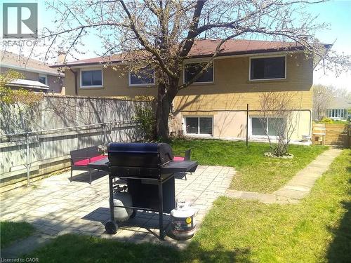Rear view of property with a fenced backyard, brick siding, and a patio area - 1492 Sandgate Crescent Unit# Upper, Mississauga, ON - Outdoor
