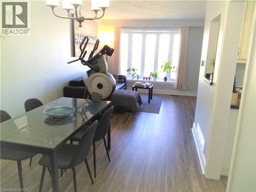 Dining space featuring wood finished floors and a chandelier - 1492 Sandgate Crescent Unit# Upper, Mississauga, ON - Indoor Photo Showing Dining Room