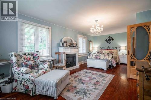 Oversized elegant Primary bedroom features hardwood floors - 99 Argyle Street N, Caledonia, ON - Indoor Photo Showing Living Room With Fireplace