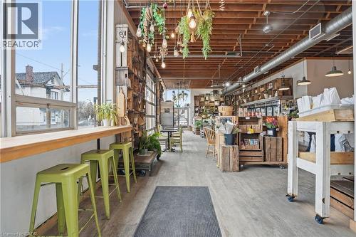 Below grade area with light wood-type flooring and a workshop area - 204 Ottawa Street N, Hamilton, ON 