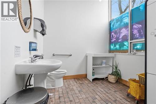 Bathroom with toilet and brick patterned flooring - 204 Ottawa Street N, Hamilton, ON 