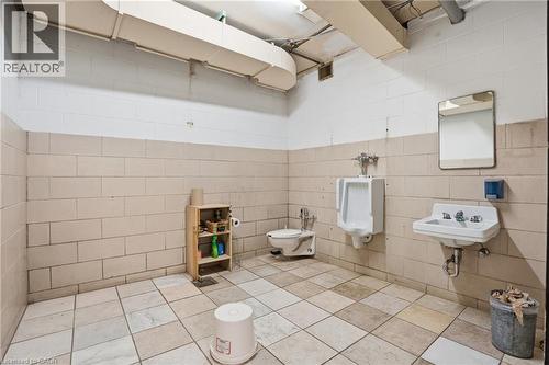 Bathroom with toilet and tile walls - 204 Ottawa Street N, Hamilton, ON 
