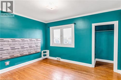 Unfurnished bedroom featuring light wood finished floors, a closet, and crown molding - 41 Floral Crescent, Kitchener, ON - Indoor Photo Showing Other Room