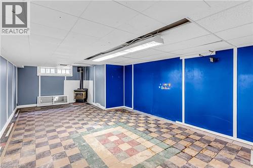 Basement with a drop ceiling and a wood stove - 41 Floral Crescent, Kitchener, ON - Indoor Photo Showing Other Room