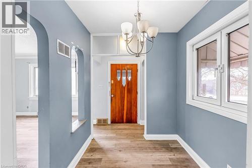 Foyer entrance featuring arched walkways, light wood finished floors, and hanging lights - 41 Floral Crescent, Kitchener, ON - Indoor Photo Showing Other Room