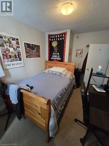 Bedroom with carpet flooring, a textured ceiling, and a desk - 9 Waterloo Avenue, Guelph, ON - Indoor Photo Showing Bedroom