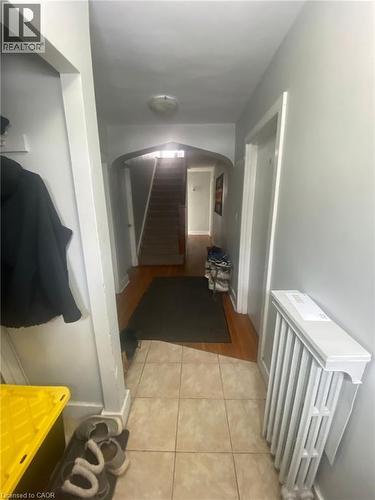 Corridor with radiator, light tile patterned floors, and arched walkways - 9 Waterloo Avenue, Guelph, ON - Indoor Photo Showing Other Room