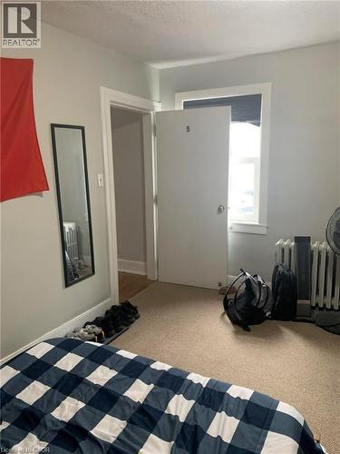 Unfurnished bedroom featuring light colored carpet and a textured ceiling - 9 Waterloo Avenue, Guelph, ON - Indoor Photo Showing Bedroom