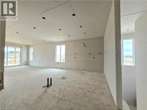 Spare room featuring plenty of natural light - 106 Thackeray Way, Harriston, ON - Indoor Photo Showing Garage