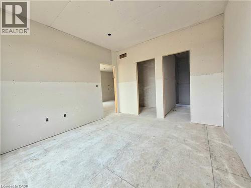 Unfurnished bedroom featuring two closets - 106 Thackeray Way, Harriston, ON - Indoor