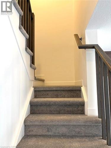 Stairway with carpet floors - 7 Pin Oak Common, Cambridge, ON - Indoor Photo Showing Other Room