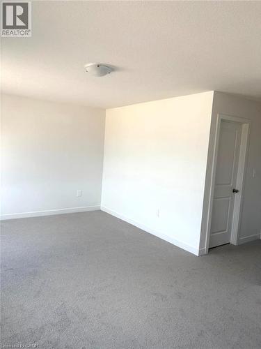 Unfurnished room featuring carpet floors and a textured ceiling - 7 Pin Oak Common, Cambridge, ON - Indoor Photo Showing Other Room