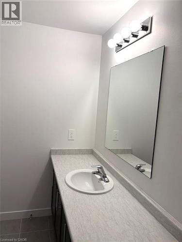 Bathroom with vanity and dark tile patterned flooring - 7 Pin Oak Common, Cambridge, ON - Indoor Photo Showing Bathroom