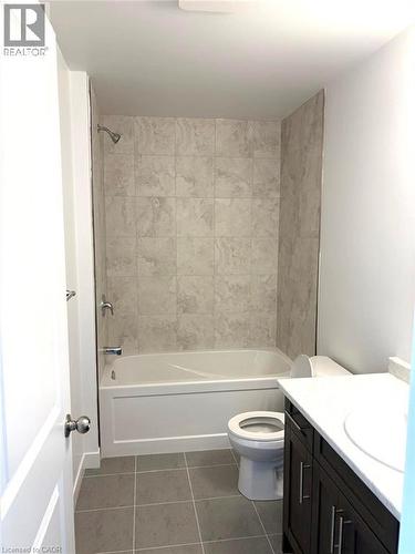 Full bath with shower / washtub combination, vanity, and dark tile patterned floors - 7 Pin Oak Common, Cambridge, ON - Indoor Photo Showing Bathroom
