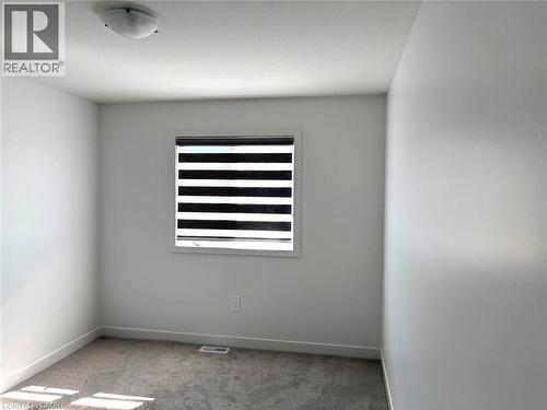 Unfurnished room featuring light colored carpet and baseboards - 7 Pin Oak Common, Cambridge, ON - Indoor Photo Showing Other Room