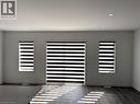Detailed view of wood finished floors and recessed lighting - 7 Pin Oak Common, Cambridge, ON  - Indoor Photo Showing Other Room 