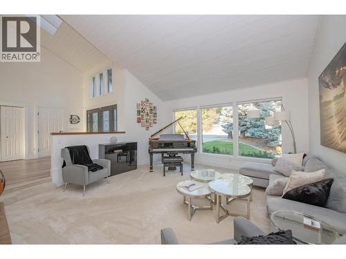 Family room to left of entry - 702 Cypress Drive, Coldstream, BC - Indoor Photo Showing Living Room