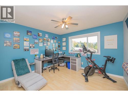 2 of 4 bedrooms upstairs, currently used as office - 702 Cypress Drive, Coldstream, BC - Indoor Photo Showing Gym Room