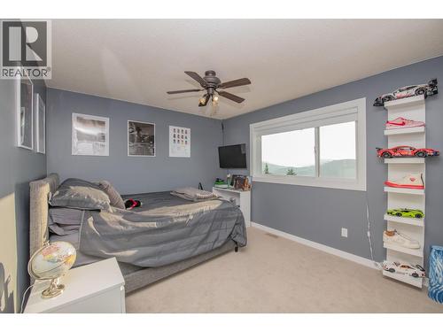 3 of 4 bedrooms upstairs - 702 Cypress Drive, Coldstream, BC - Indoor Photo Showing Bedroom