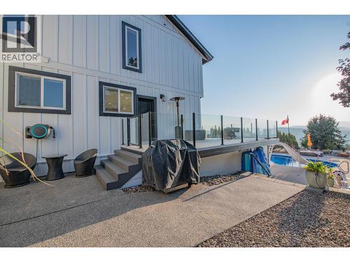 Steps from deck leading to pool/ outdoor area - 702 Cypress Drive, Coldstream, BC - Outdoor With Exterior