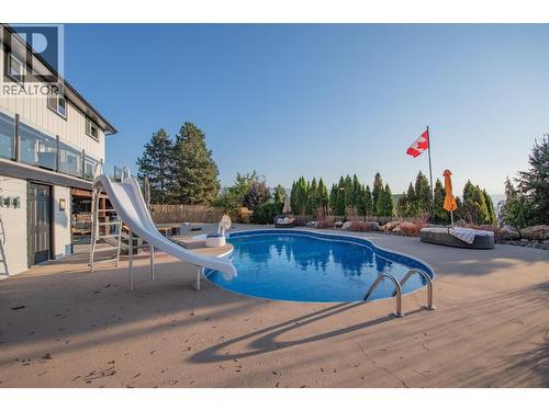 Salt water pool with slide - 702 Cypress Drive, Coldstream, BC - Outdoor With In Ground Pool