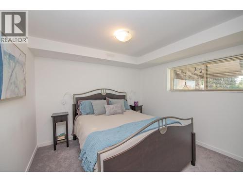 Lower bedroom - 702 Cypress Drive, Coldstream, BC - Indoor Photo Showing Bedroom