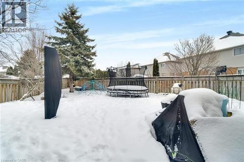 The property features a fenced backyard with a mature evergreen tree - 191 Hawkswood Trail, Hamilton, ON - Outdoor