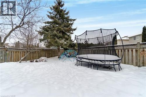 The property features an outdoor yard with a wooden fence and a variety of trees - 191 Hawkswood Trail, Hamilton, ON - Outdoor