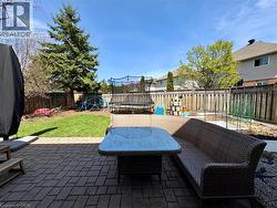 Patio space featuring brick pavers and a perimeter fence - 