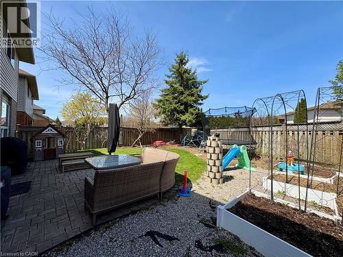 Expansive backyard featuring a paver patio, gravel areas, and a manicured lawn - 191 Hawkswood Trail, Hamilton, ON - Outdoor