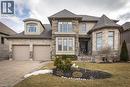 View of front of house with a shingled roof, driveway, stone siding, and a front lawn - 2719 Torrey Pines Way, London, ON  - Outdoor With Facade 