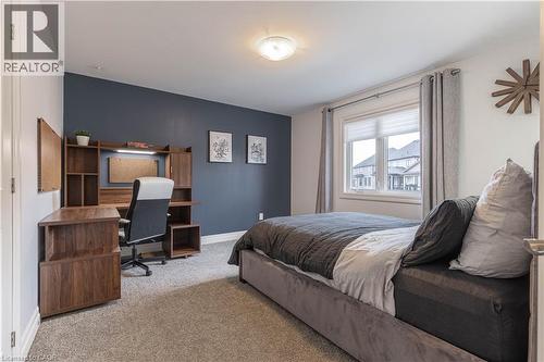 Bedroom featuring an accent wall, carpet flooring, and a desk - 2719 Torrey Pines Way, London, ON - Indoor Photo Showing Bedroom