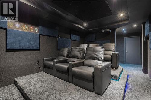 Home theater with carpet floors and a tray ceiling - 2719 Torrey Pines Way, London, ON - Indoor