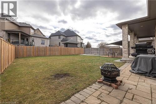 Fenced backyard with a patio, an outdoor fire pit, and a residential view - 2719 Torrey Pines Way, London, ON - Outdoor With Deck Patio Veranda