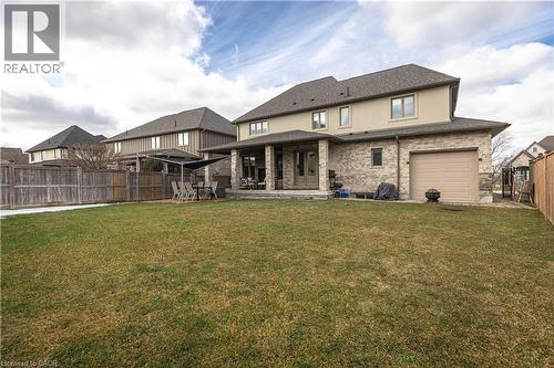 Back of house featuring a patio area, a fenced backyard, brick siding, and a garage - 2719 Torrey Pines Way, London, ON - Outdoor With Deck Patio Veranda
