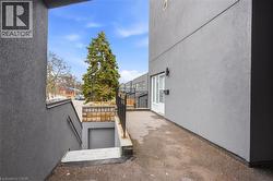 View of property exterior featuring stucco siding and a balcony - 